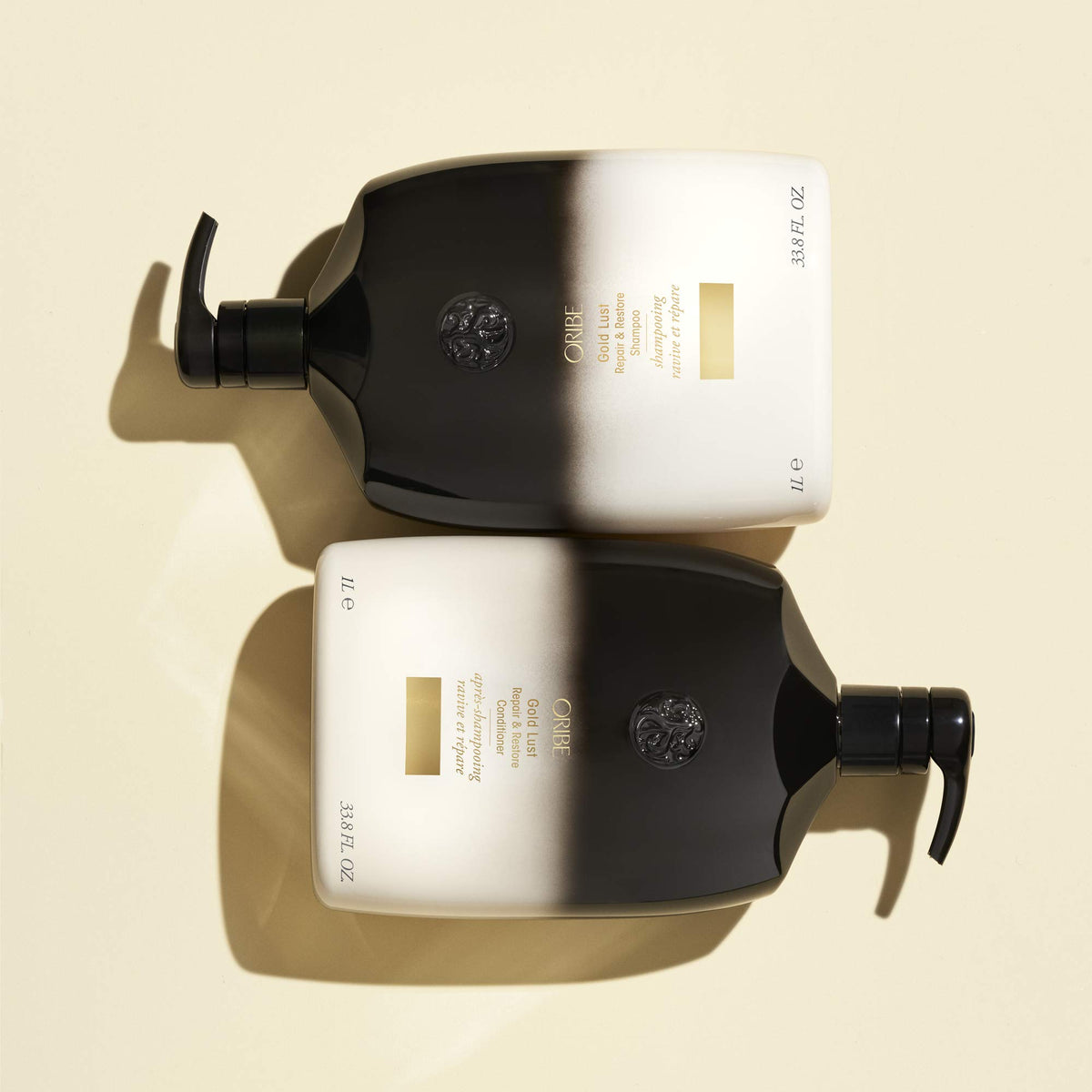 Oribe Gold Lust 33.8 oz bottle next to common items to show large professional size