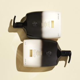 Oribe Gold Lust 33.8 oz bottle next to common items to show large professional size