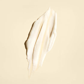 Oribe conditioner on bathroom shelf conveying stylish grooming routine