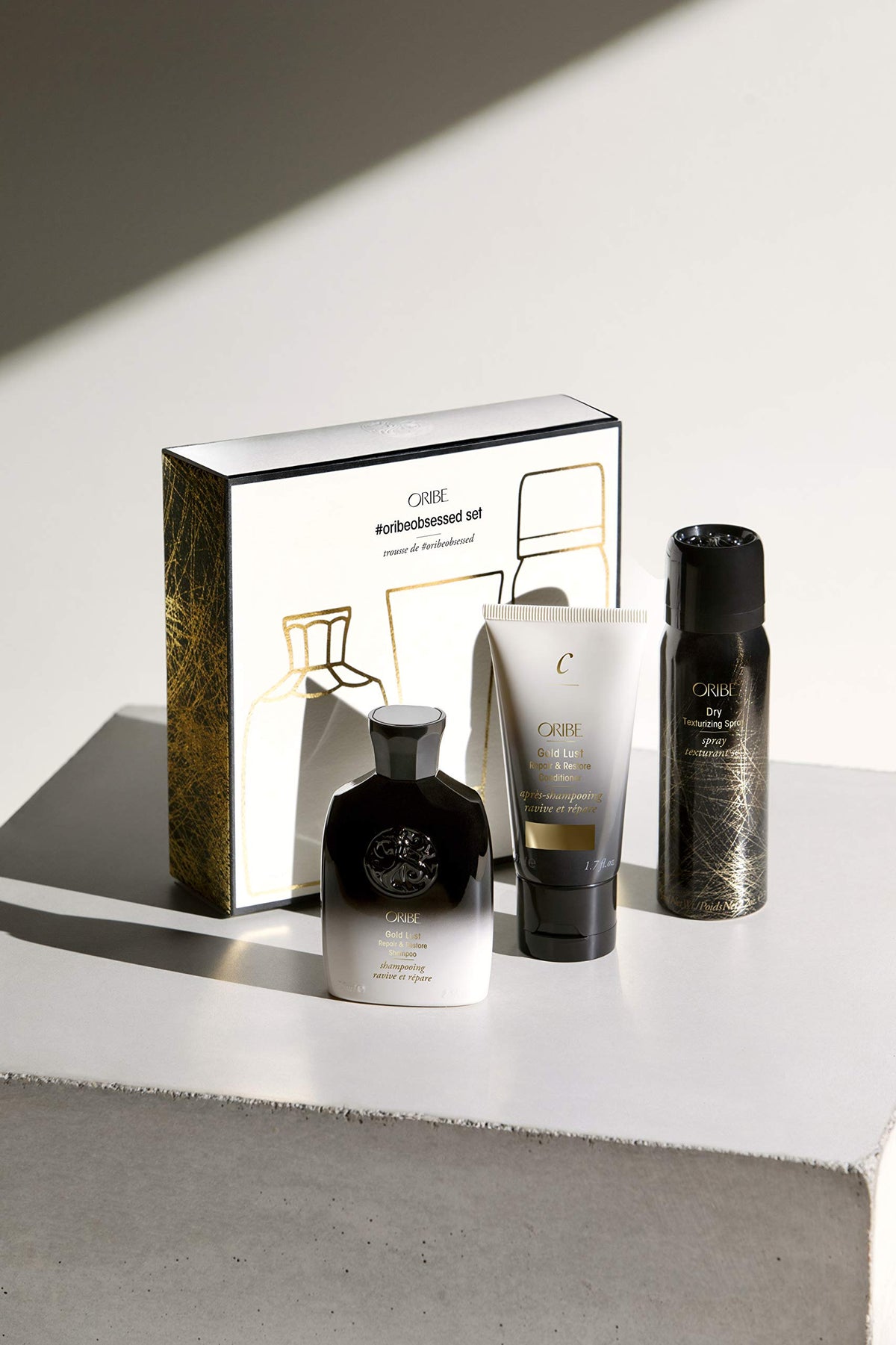Gold Lust Shampoo close-up bottle label and texture, showing nourishing benefits by Oribe