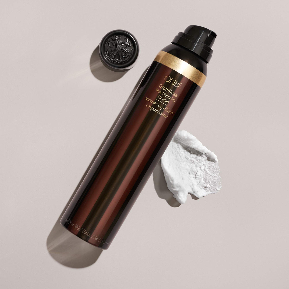 Oribe Grandiose next to ruler to show 5.7 oz scale and travel-friendly size