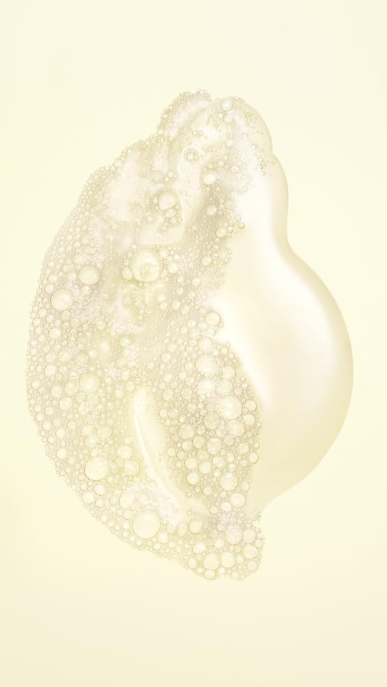 Oribe creamy lather texture demonstrating gentle cleansing and moisture retention