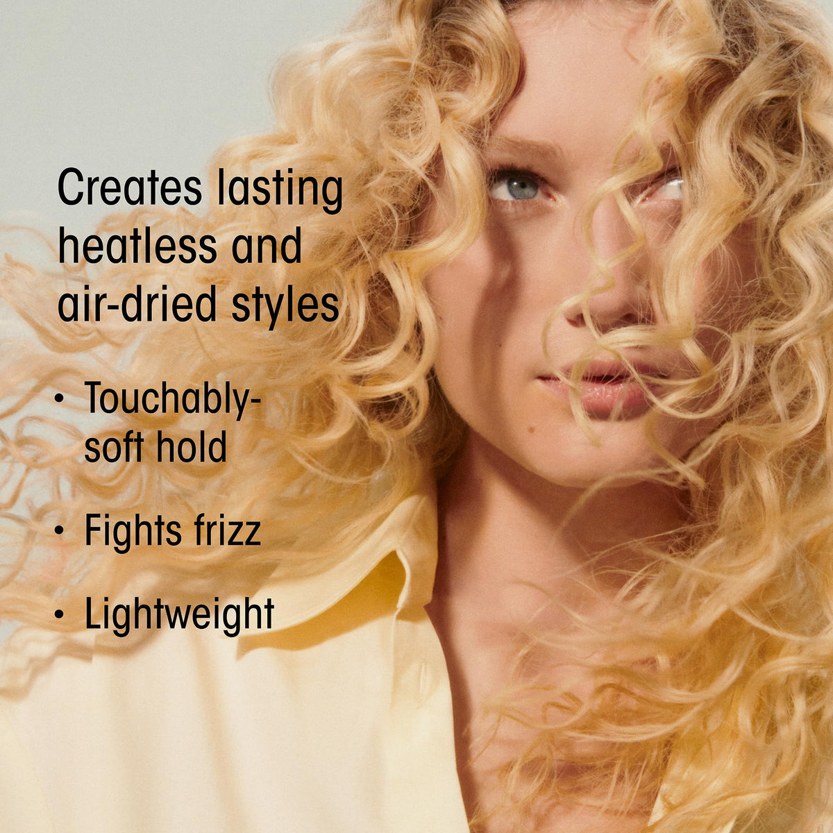 Oribe Hair Alchemy applied to hair by hand demonstrating easy styling and definition