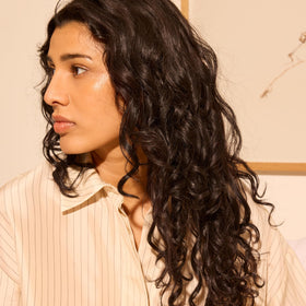 Oribe Hair Alchemy lifestyle photo by the sea evoking Côte d’Azur scent and fresh finish
