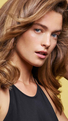 Shiny wet hair after using Oribe conditioner demonstrating smoother finish