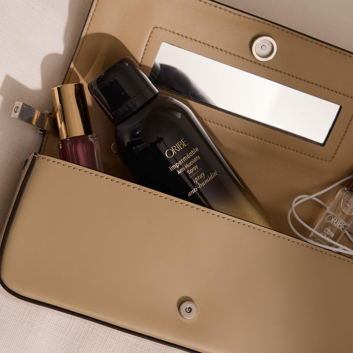 Oribe Impermeable before and after hair comparison highlighting frizz reduction and smooth finish