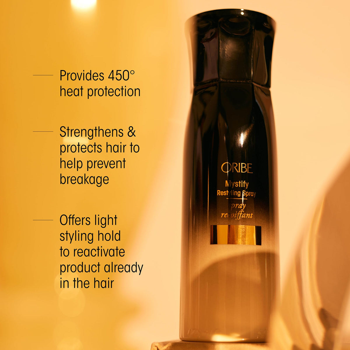 Oribe travel-size bottle in hand for convenient on-the-go refreshes