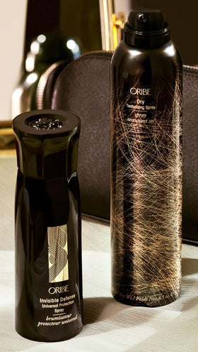 Fine mist spray from Oribe bottle demonstrating easy, even application for heat protection