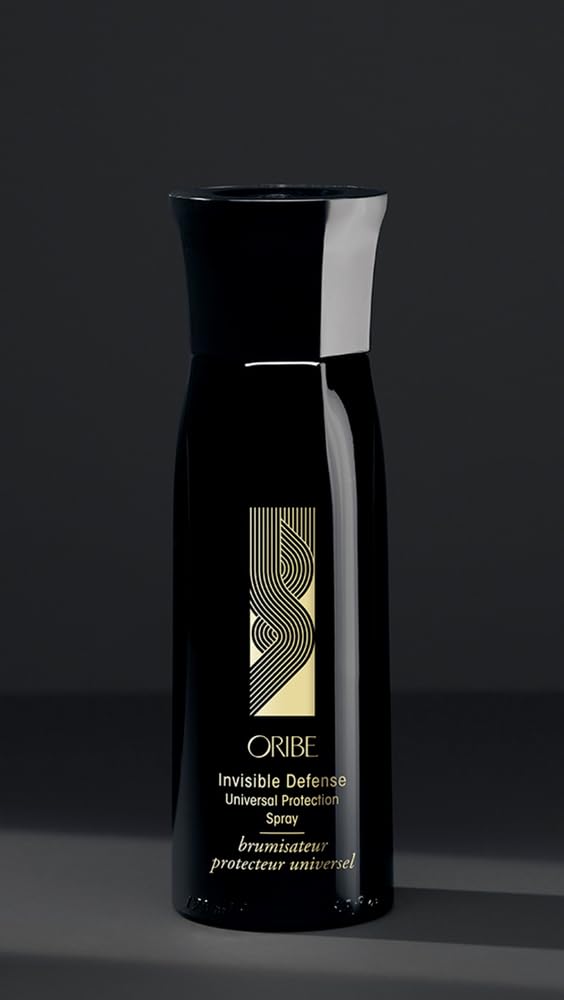 Oribe Invisible Defense next to a ruler and travel items to show the 5.9 oz size for portability