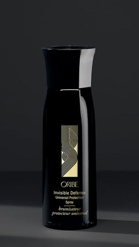 Oribe Invisible Defense next to a ruler and travel items to show the 5.9 oz size for portability