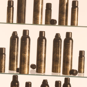 Oribe lifestyle hair model with voluminous styled hair illustrating lasting texture benefit