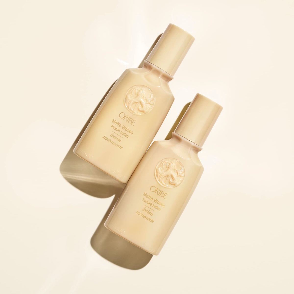Oribe matte waves bottle in hand to show scale and travel-friendly size advantage