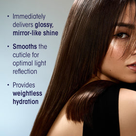 ORIBE bottle staged with styling tools indicating professional salon-ready benefit
