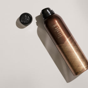 Oribe mist dispersing into hair showing texture and thickness enhancement for fuller-looking locks