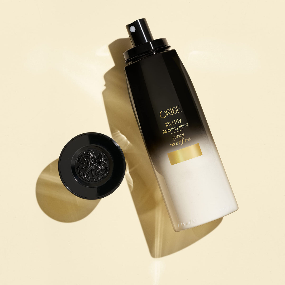 Oribe Mystify spray mist in hair during styling, lightweight hydration benefit