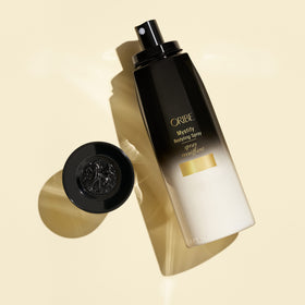 Oribe Mystify spray mist in hair during styling, lightweight hydration benefit