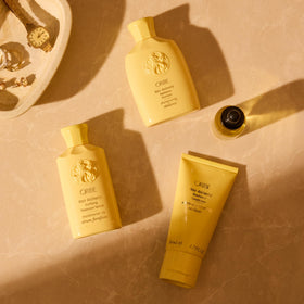 Oribe shampoo placed in a bathroom shelf scene suggesting elevated daily routine