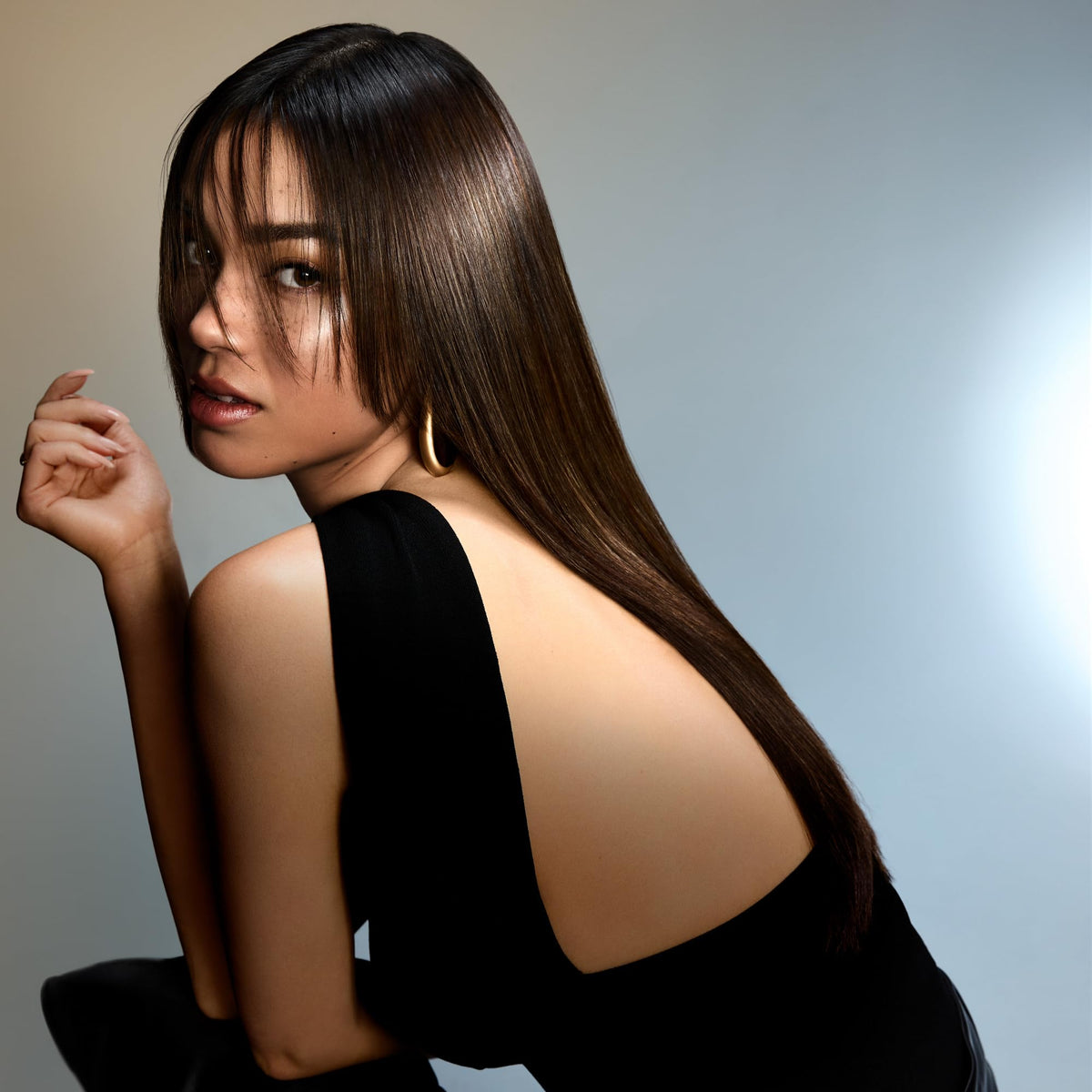 Oribe Run-Through being applied to wet hair to detangle and prepare for styling