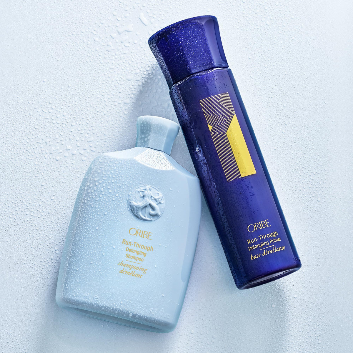 Oribe Run-Through on shower shelf lifestyle image conveying salon-quality luxury