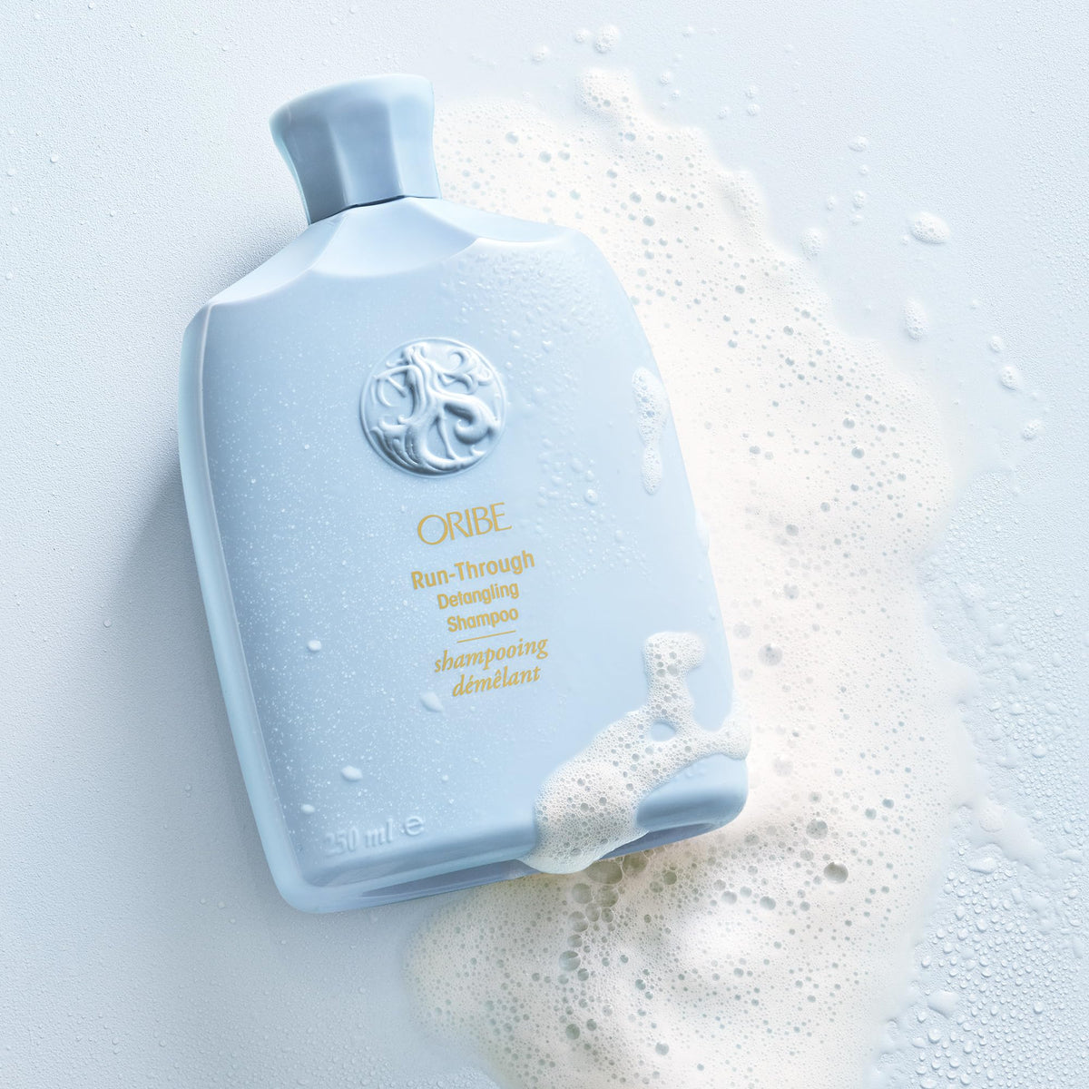 Oribe Run-Through paired with Oribe conditioner showing complementary routine benefits