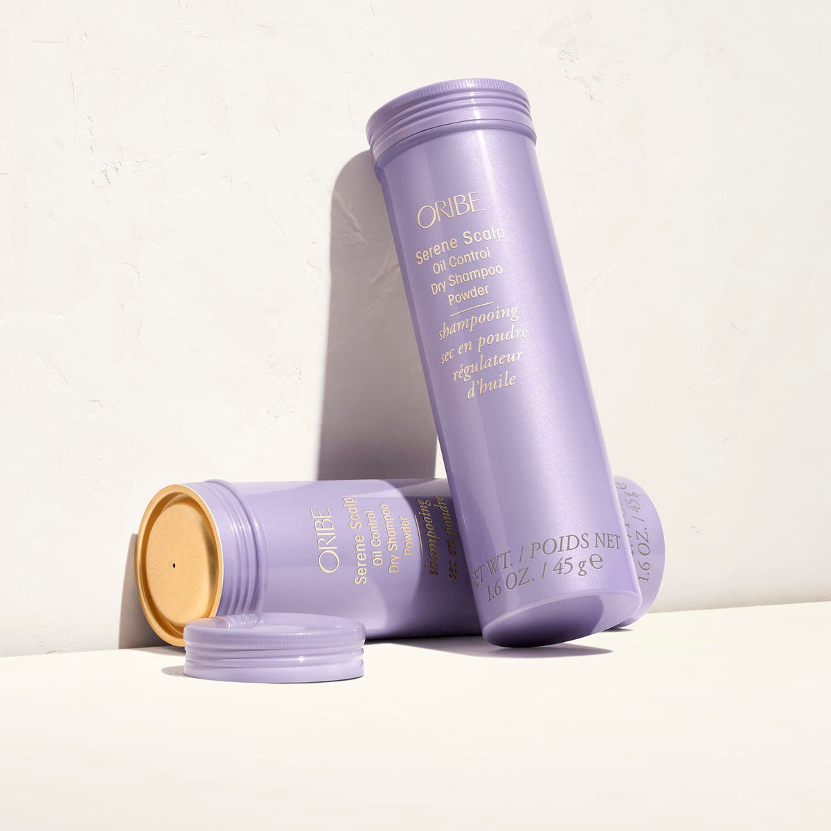 Oribe Serene Scalp held in hand to show size and easy portability for travel convenience