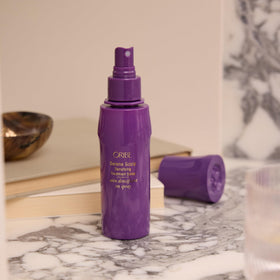 ORIBE product next to a ruler for scale, showing 4.2oz size and travel-friendly dimensions