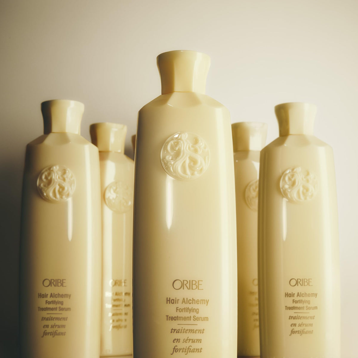 Oribe serum paired with shampoo and conditioner showing system-strengthening benefit