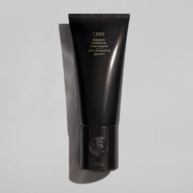 Creamy texture of Oribe Signature Conditioner showing rich hydration and smoothness
