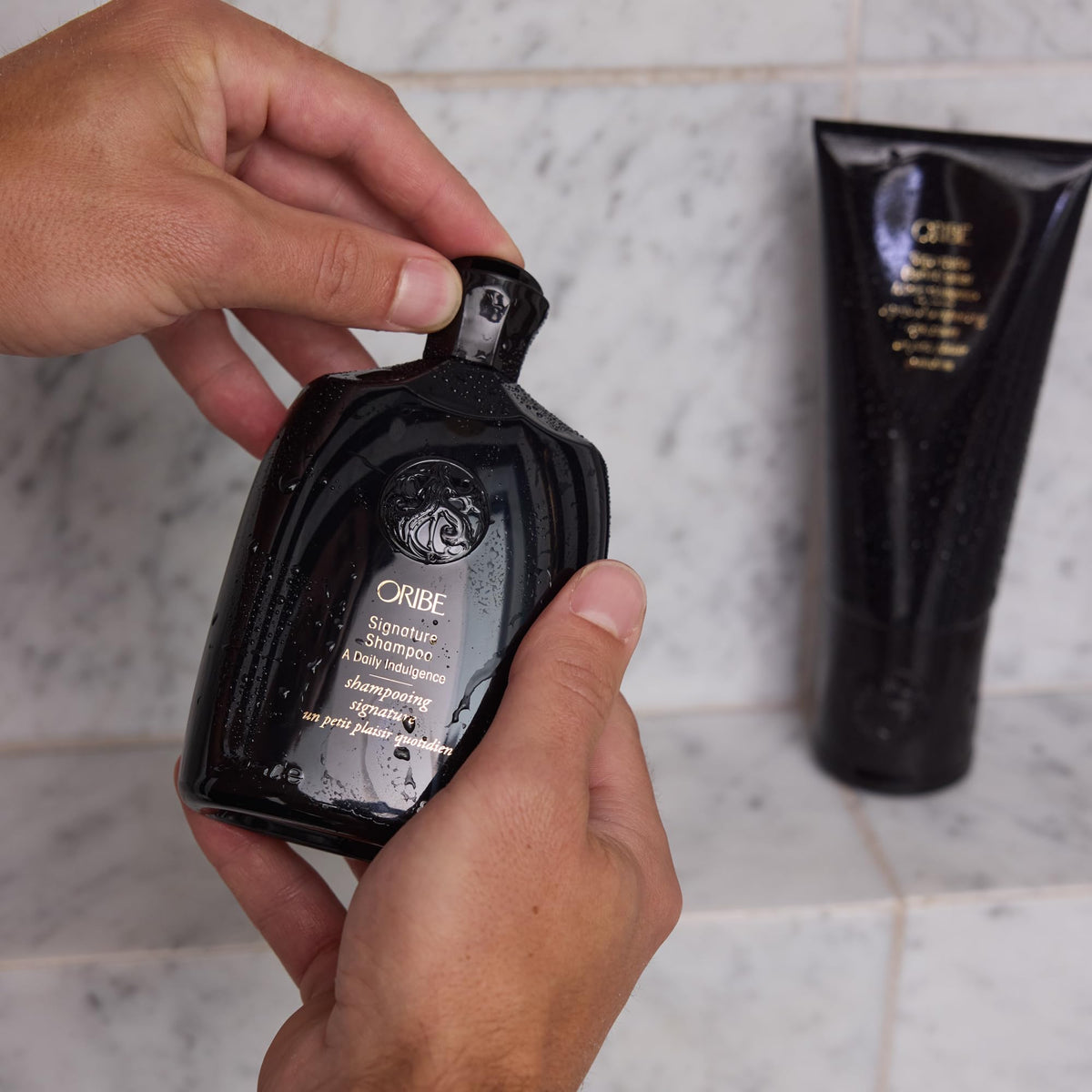 Oribe Signature Shampoo after-wash shine on hair showing smooth, glossy finish