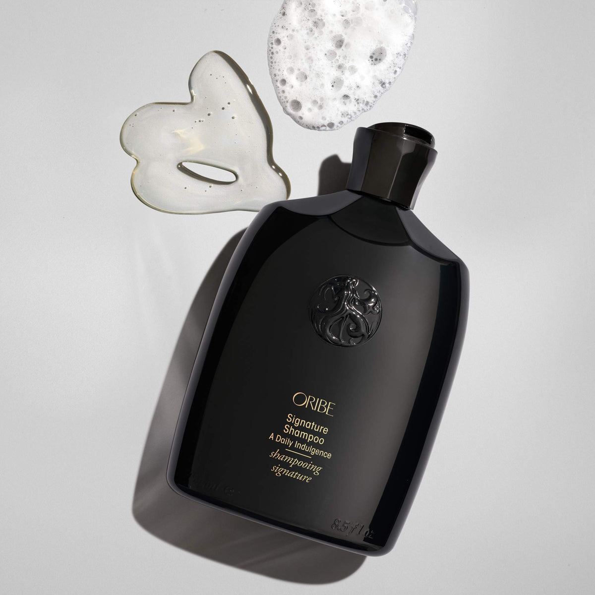 Oribe Signature Shampoo creamy foam texture demonstrating gentle cleanse benefit