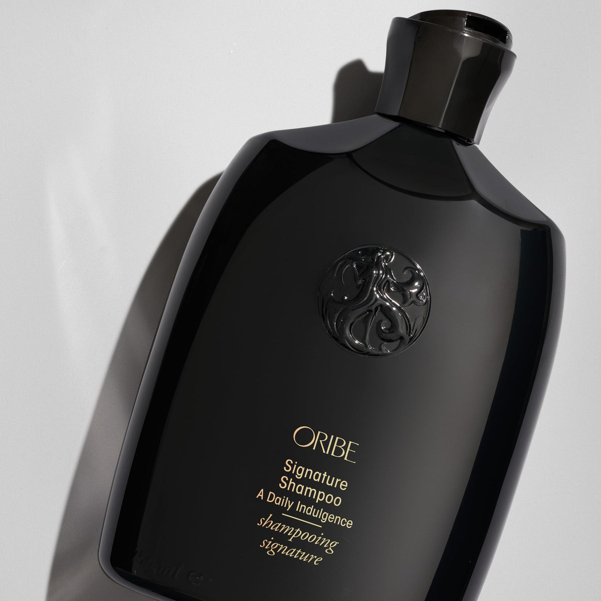 Oribe Signature Shampoo pump close-up highlighting easy dispensing and controlled use
