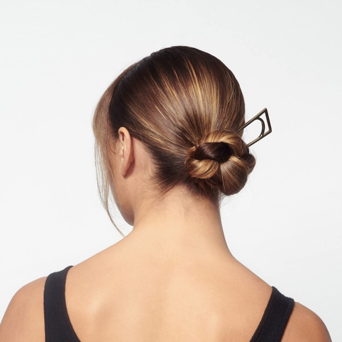 Oribe Superfine bottle in hand illustrating 9 oz scale and easy application