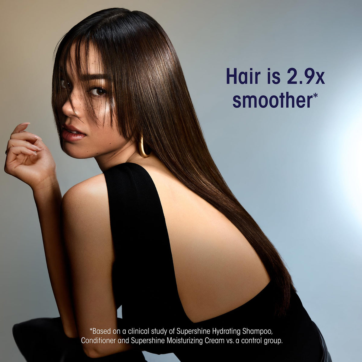 Oribe Supershine applied to hair from hand demonstrating ease of distribution and control
