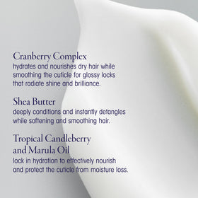 Oribe Supershine bottle staged with styling tools conveying salon-grade finish and shine