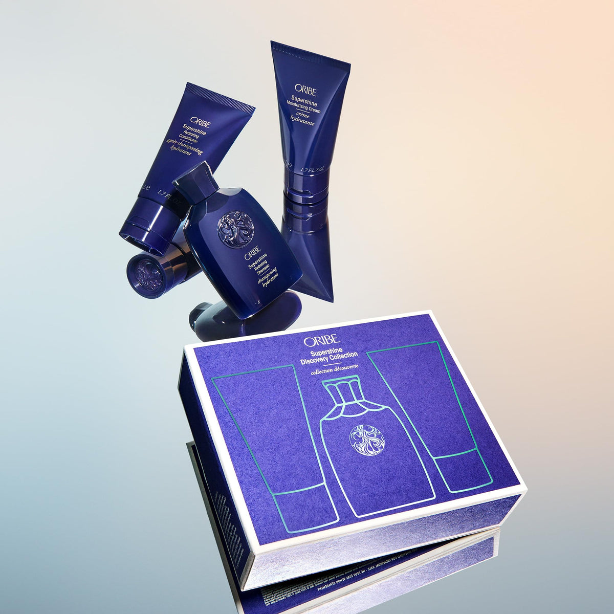 Oribe Supershine lifestyle travel setup on suitcase showing glossy hair results