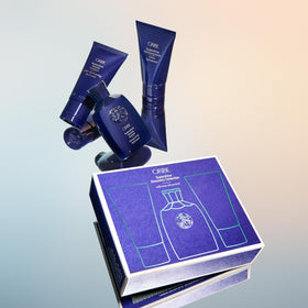 Oribe Supershine lifestyle travel setup on suitcase showing glossy hair results