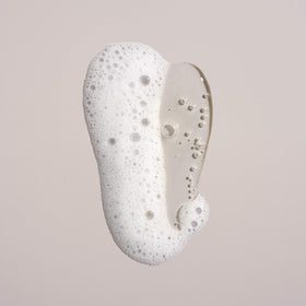 Oribe shampoo lather texture on hand illustrating lightweight foam and gentle cleansing