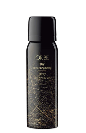 Three Oribe products on a bathroom shelf, travel-ready styling and repair by Oribe
