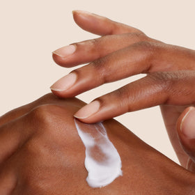Origins GinZing open jar top view showing creamy formula for radiance