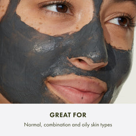 Origins jar beside bamboo charcoal and kaolin clay, showing natural active ingredients
