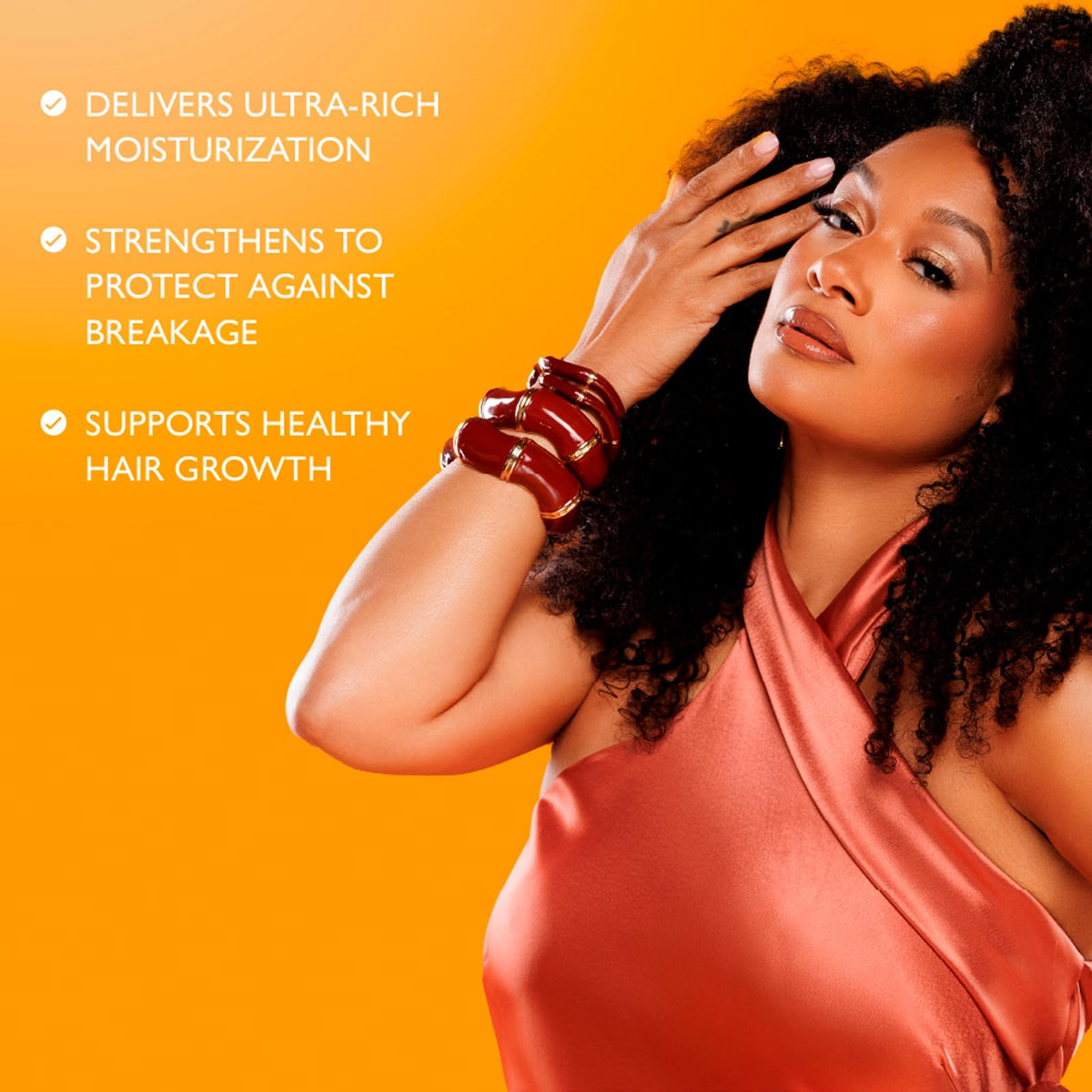 ORS being applied to curly hair to enhance detangling and softness benefits