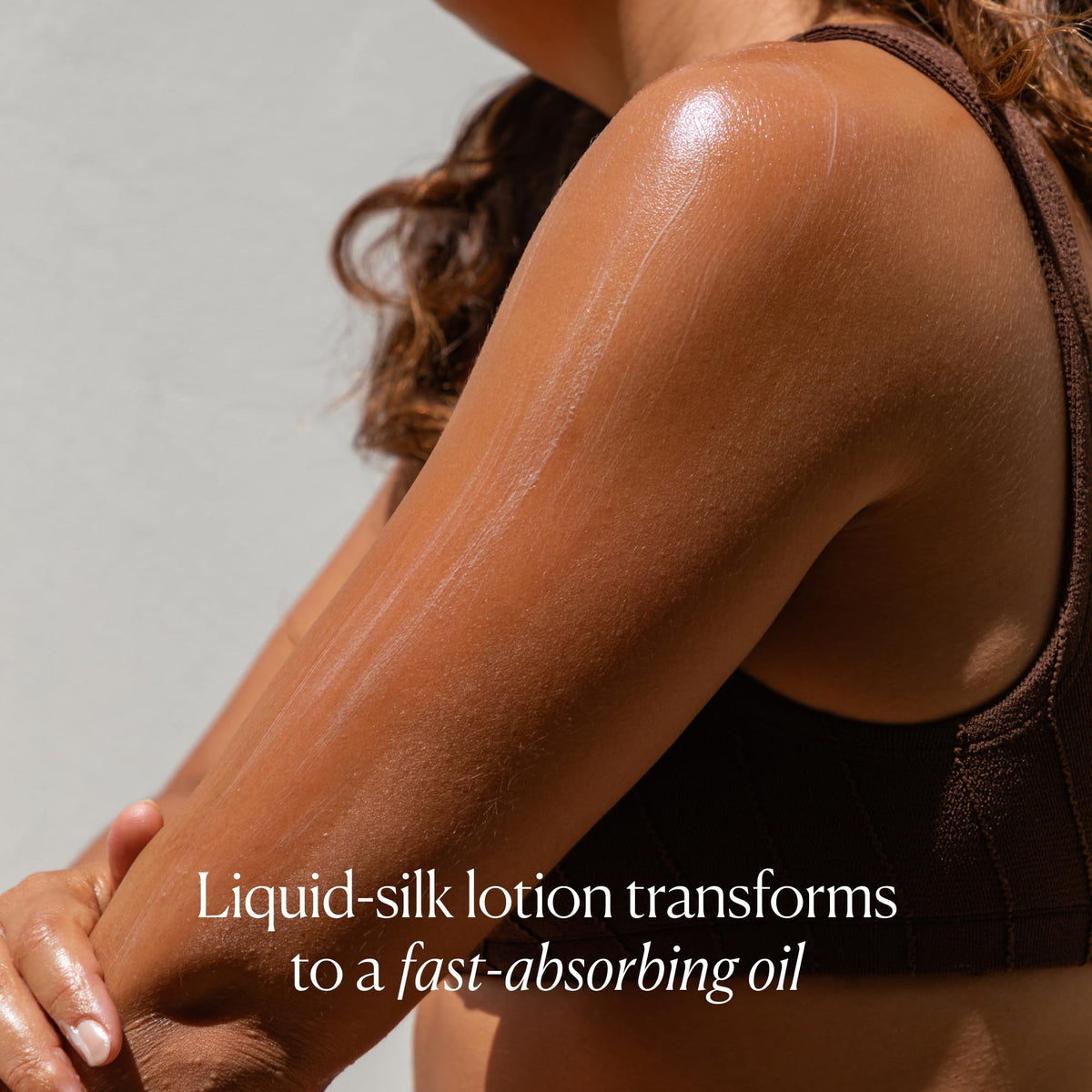 OSEA balm being smoothed on arm to show fast absorption and firmer look