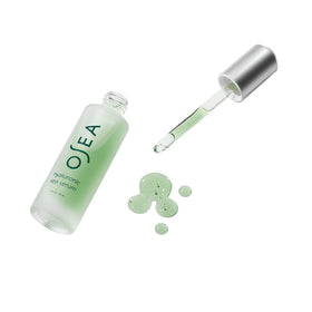OSEA serum next to moisturizer in bathroom setting for layering benefit