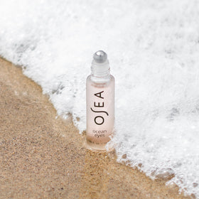 OSEA applying roller under-eye demonstrating de-puffing action