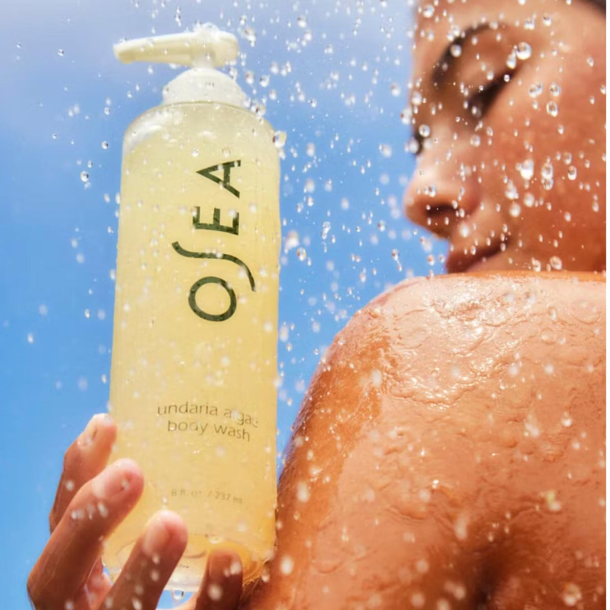 OSEA bottle held in hand for scale showing convenient 8 oz size benefit