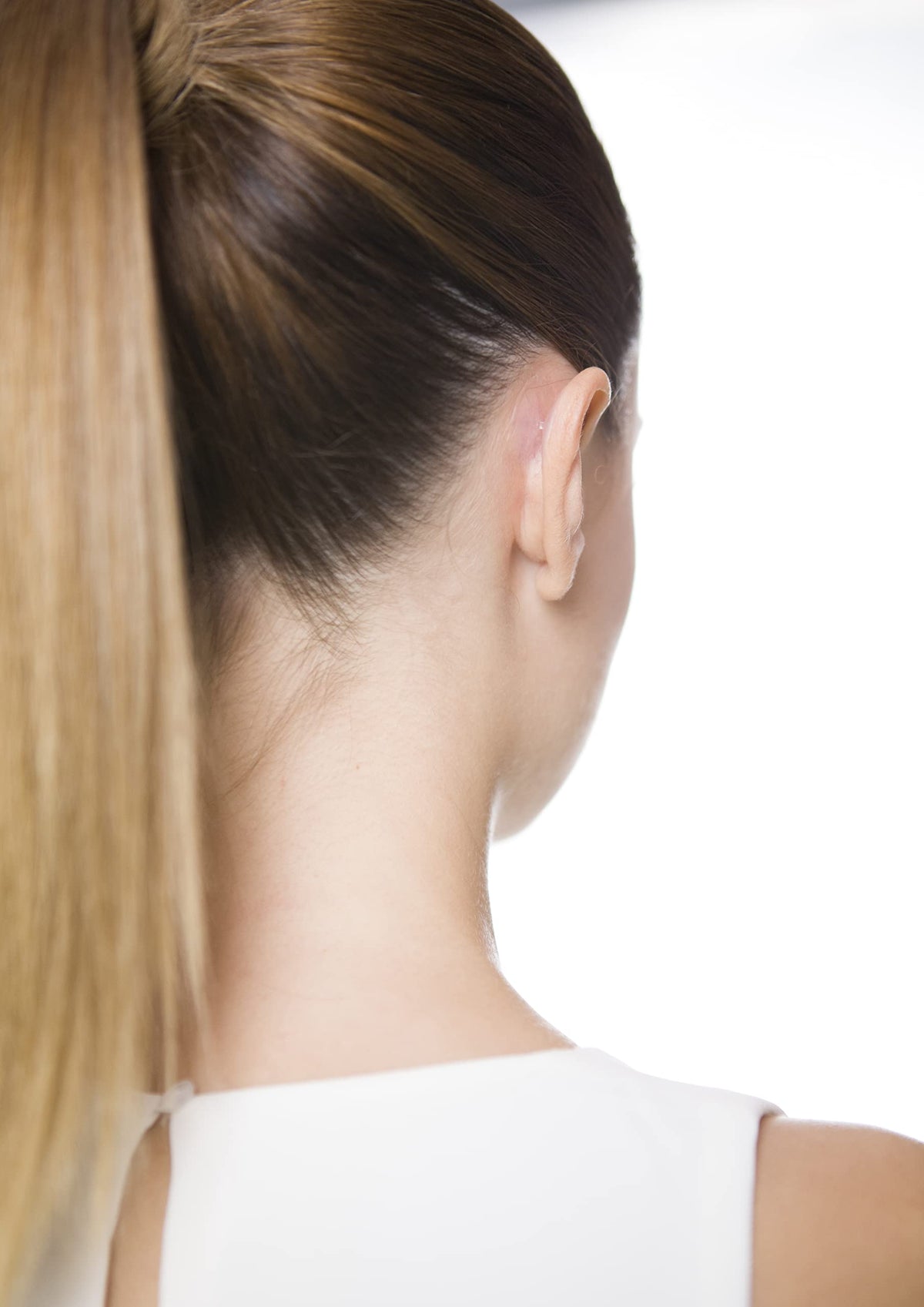 Person with styled hair concealing Otostick for natural look