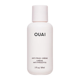 OUAI anti frizz cream front packaging shows compact travel tube and branding benefit frizz control