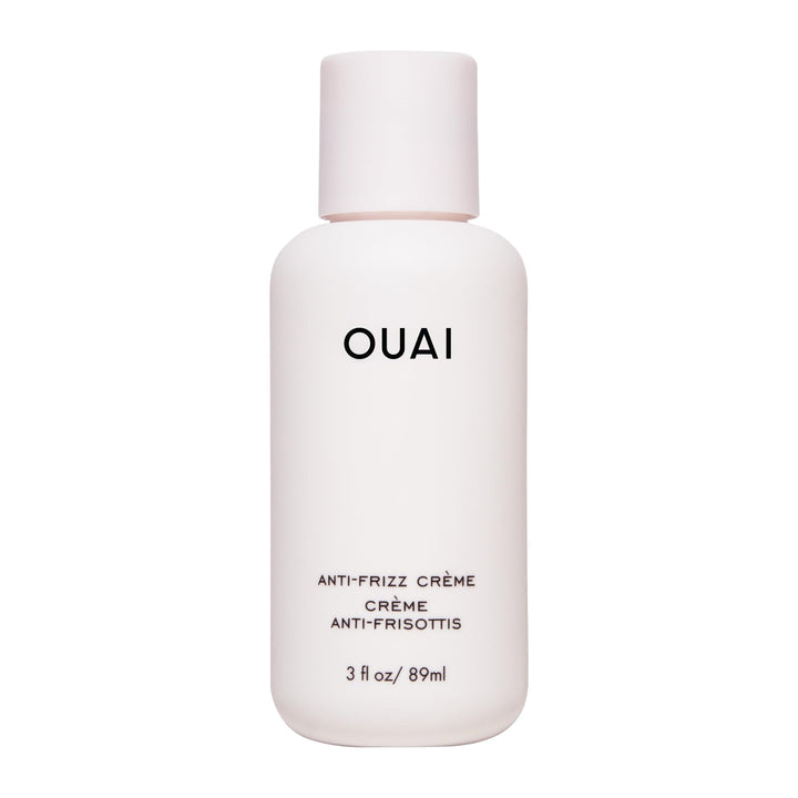 OUAI anti frizz cream front packaging shows compact travel tube and branding benefit frizz control