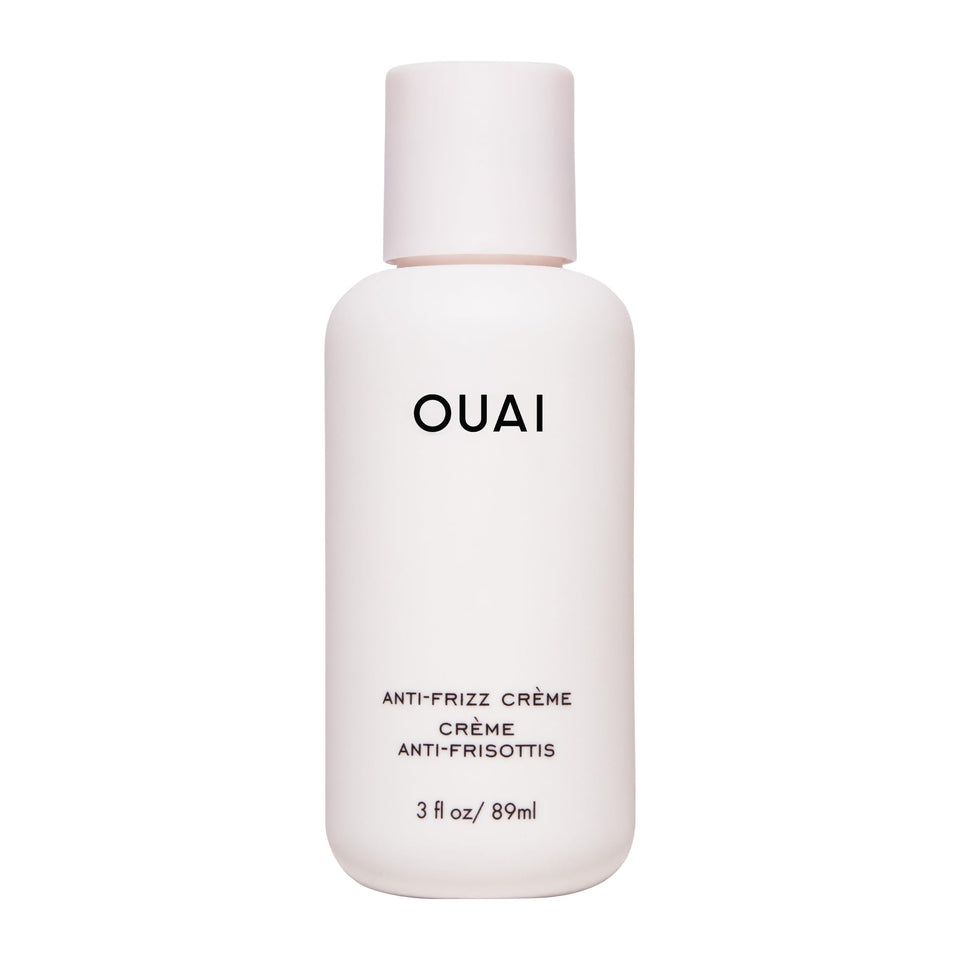 OUAI anti frizz cream front packaging shows compact travel tube and branding benefit frizz control