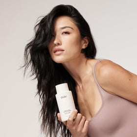 OUAI conditioner texture close-up highlighting creamy consistency for easy detangling